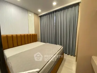 Modern bedroom with stylish headboard and floor-to-ceiling curtains in a cozy apartment.