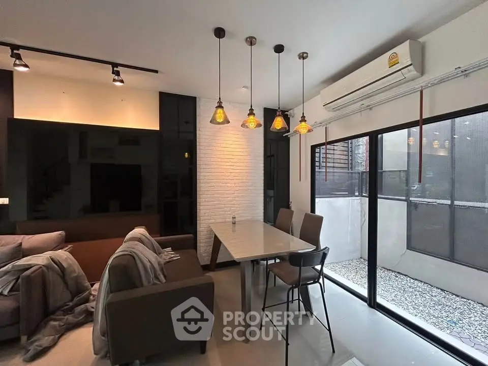 Modern living room with stylish lighting and large windows for natural light