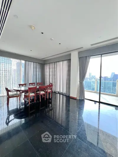 Spacious dining area with city view and elegant furnishings in a modern high-rise apartment.