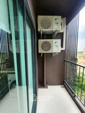 Modern balcony with air conditioning units and city view, perfect for urban living.