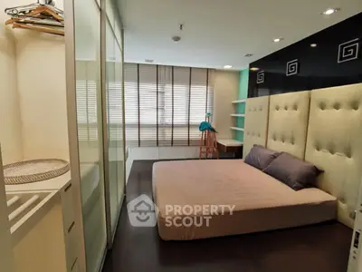 Spacious modern bedroom with stylish decor and ample natural light