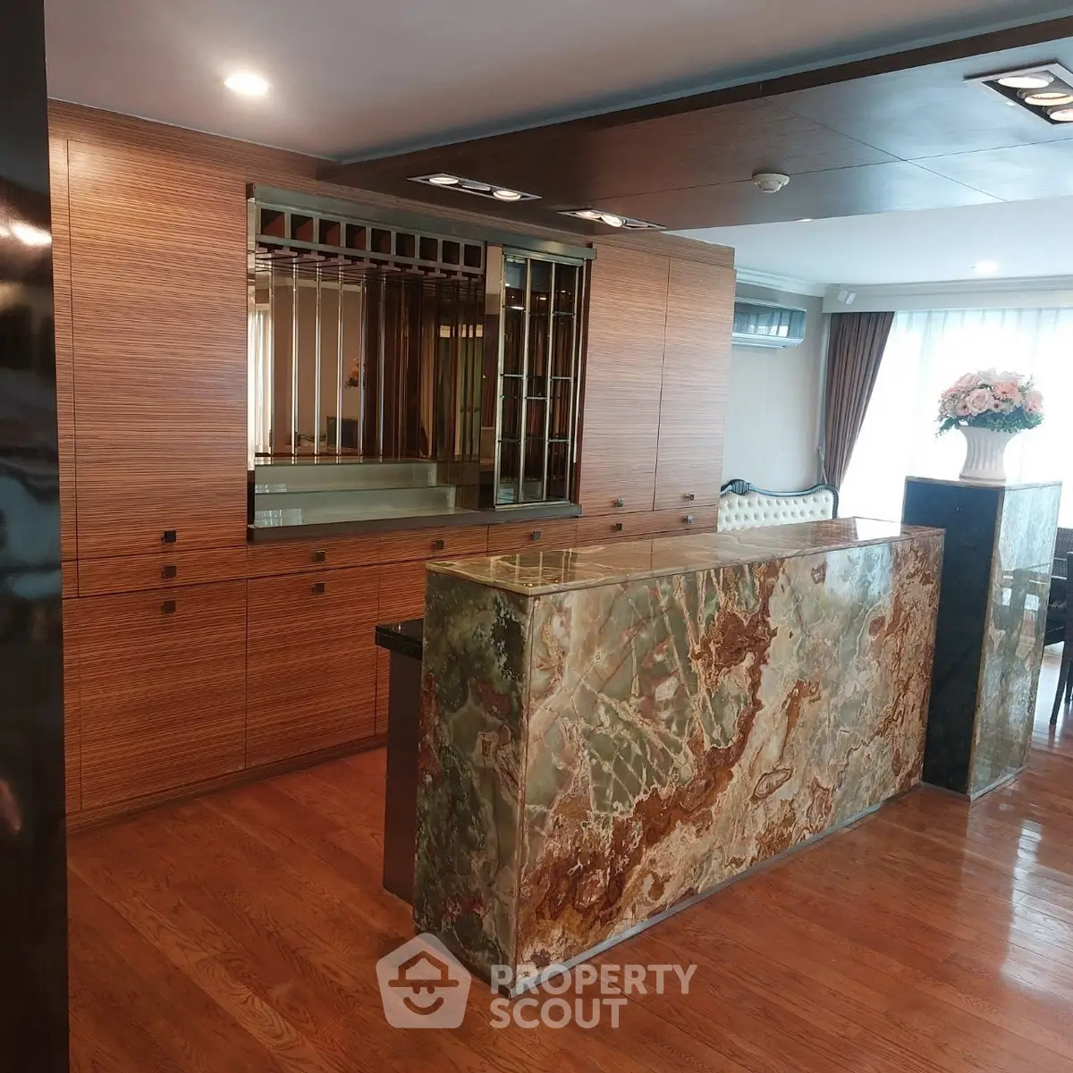 Luxurious living room with elegant wooden cabinetry and stunning marble bar counter