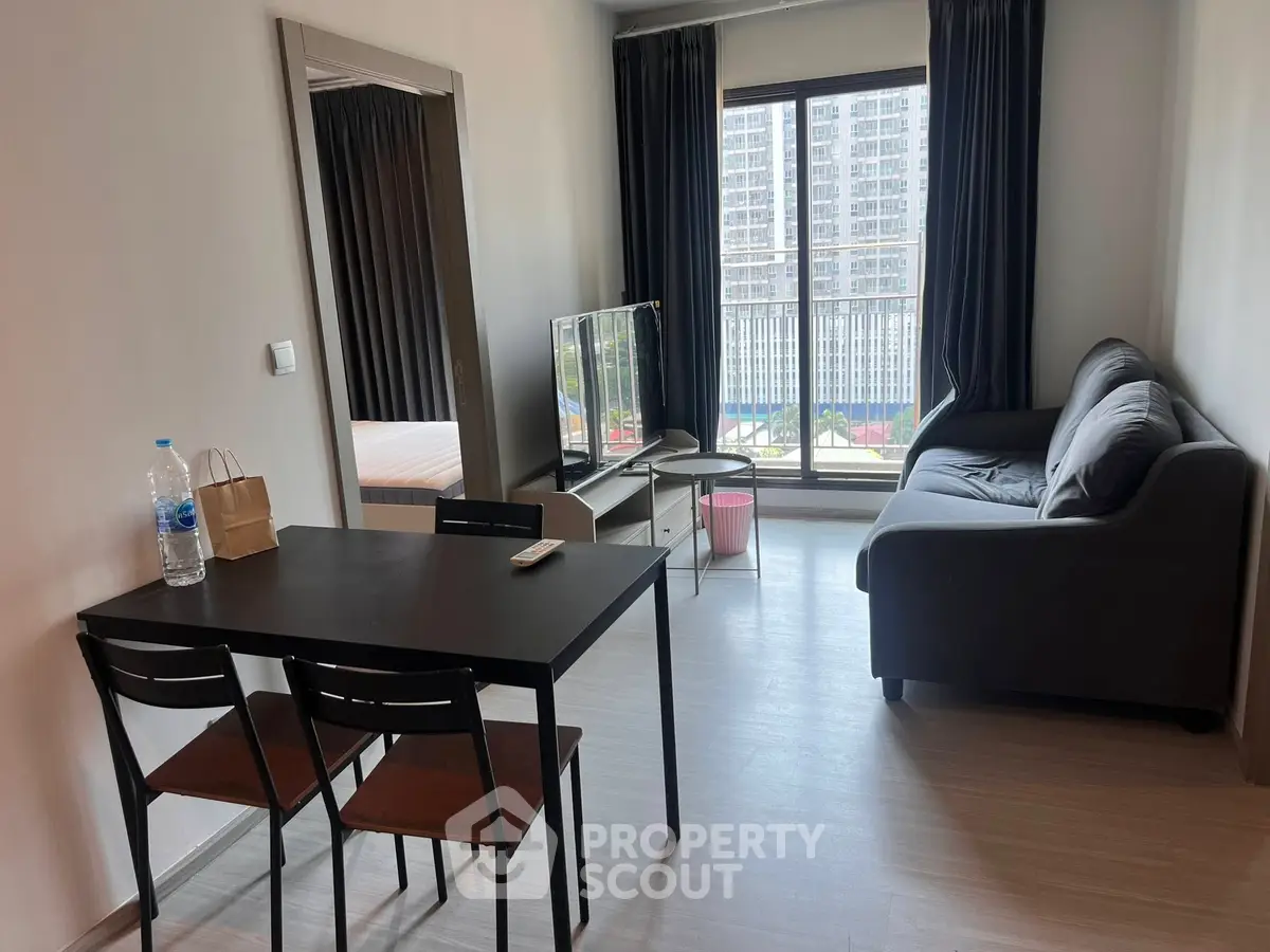 Modern living room with sleek furniture and city view balcony in urban apartment