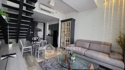 Modern living room with stylish staircase and cozy seating area in a contemporary apartment.