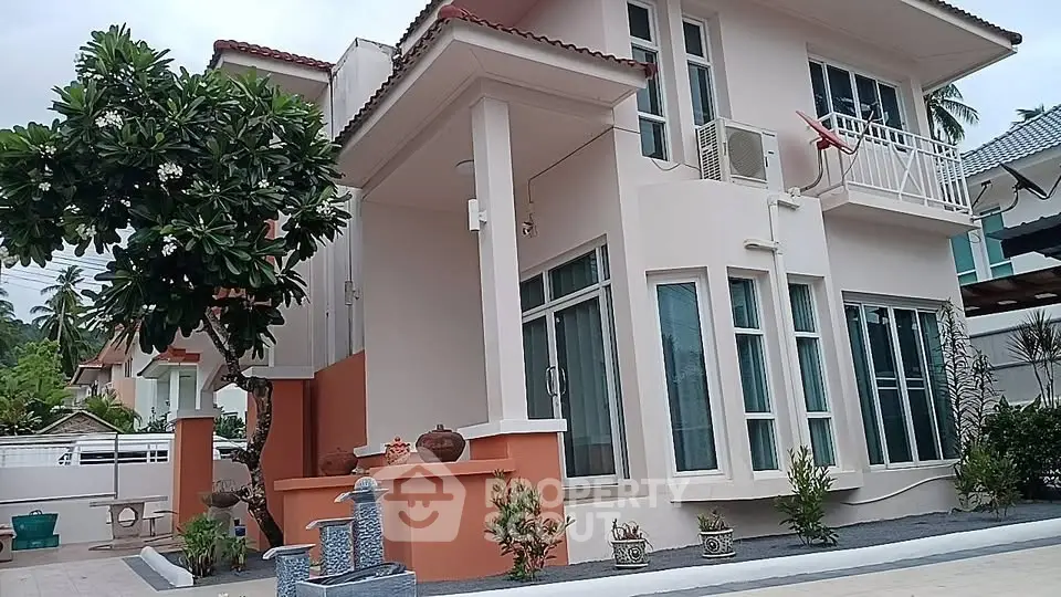 Charming two-story house with modern design and lush garden in a serene neighborhood.