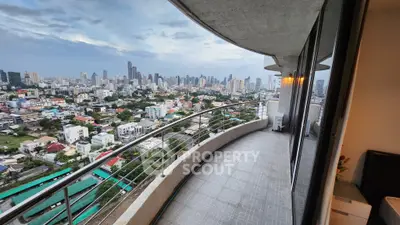 Stunning cityscape view from a spacious balcony in a high-rise apartment.