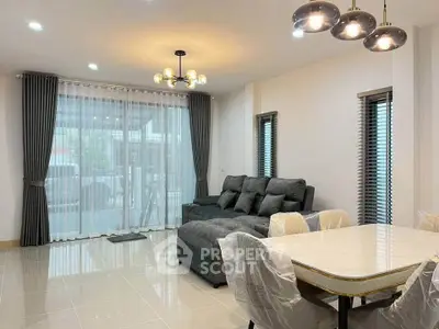 Spacious modern living room with elegant gray sofa and chic lighting