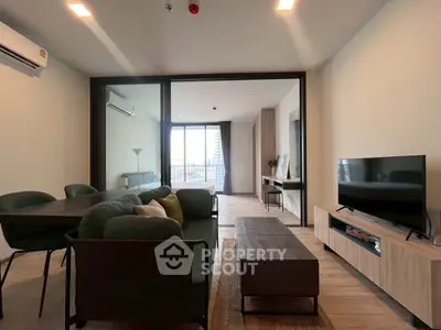 Modern living room with stylish furniture and large windows offering city view