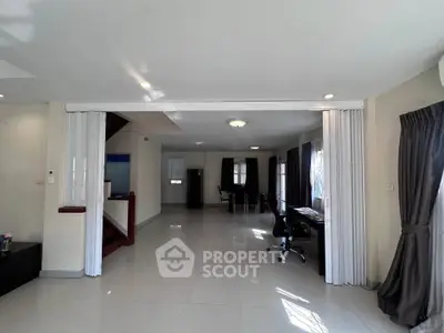 Spacious open-plan living area with modern decor and ample natural light