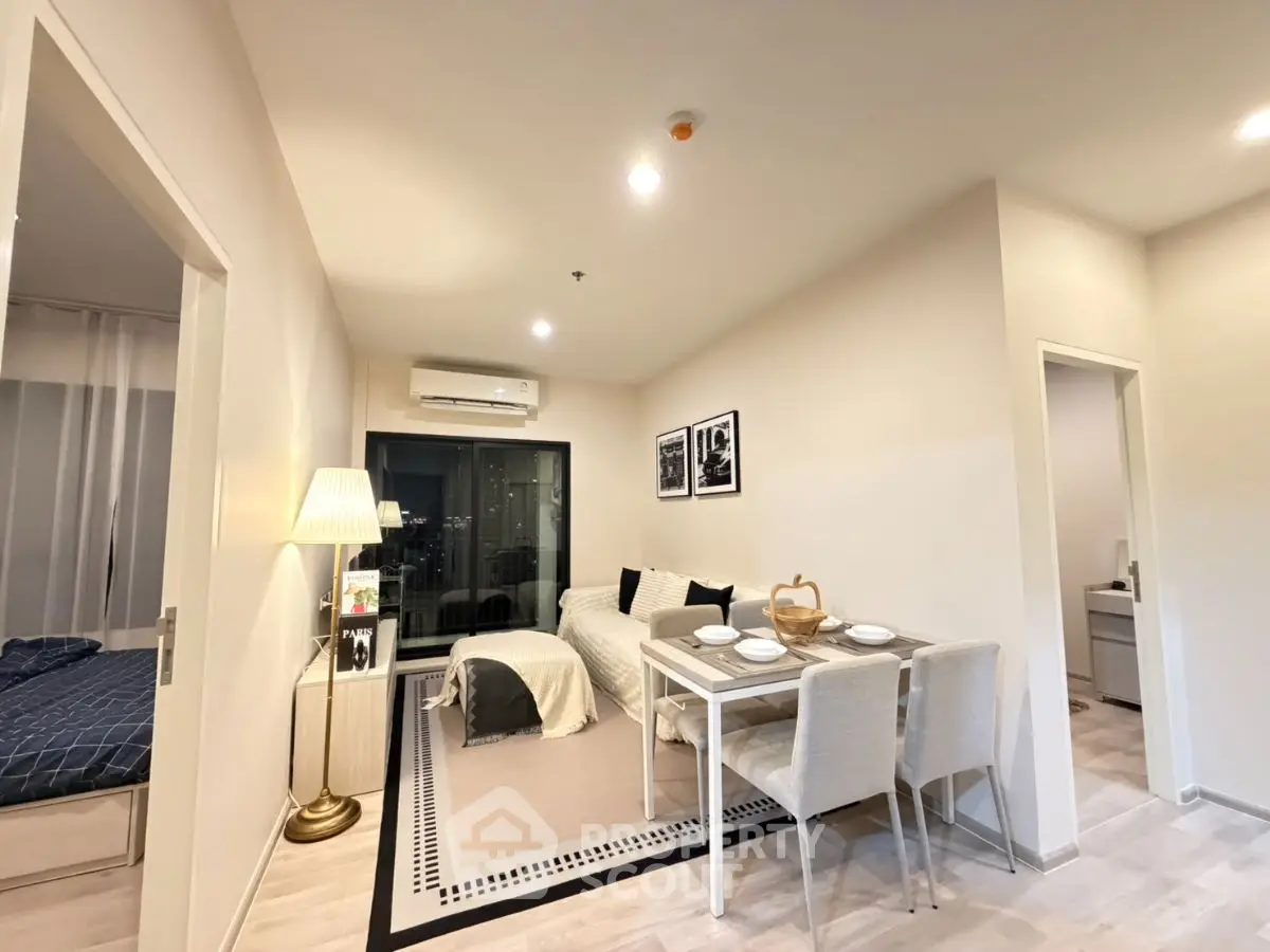 Modern living room with dining area and cozy bedroom view