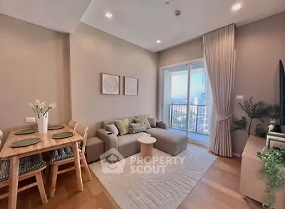 Modern living room with cozy sofa, dining area, and balcony view in stylish apartment.