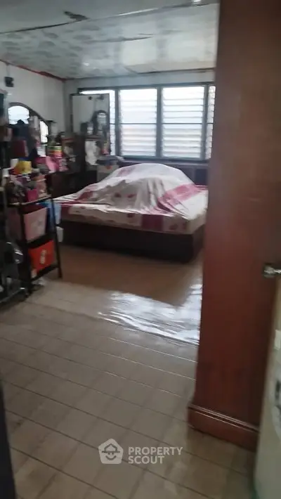 Cozy bedroom with tiled flooring and ample natural light