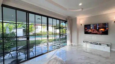 Luxurious living room with pool view and elegant marble flooring