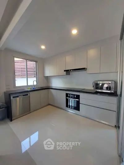 Modern kitchen with sleek cabinetry and built-in appliances in a bright, spacious layout.