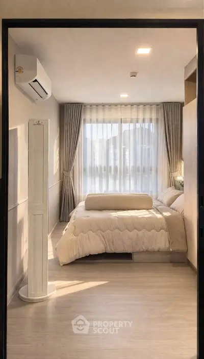Modern bedroom with elegant decor and natural light, featuring a cozy bed and stylish curtains.
