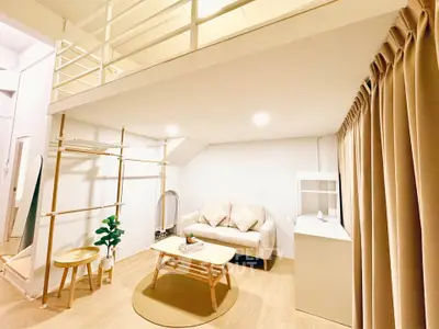 Modern loft-style living room with cozy sofa and wooden furniture