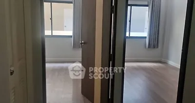 Spacious modern apartment with two bright rooms and large windows.