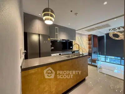 Modern kitchen with sleek design and open layout, featuring high-end appliances and stylish lighting.