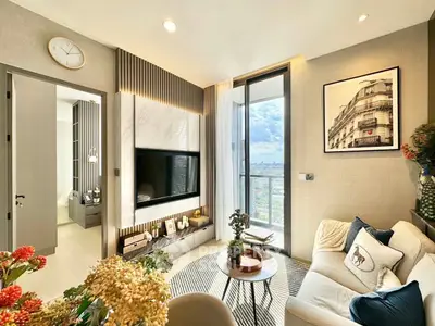 Modern living room with stylish decor and city view balcony in luxury apartment.
