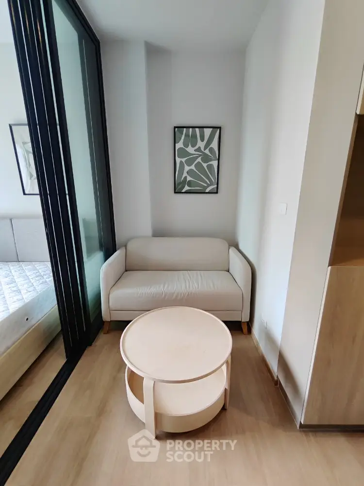 Cozy corner with modern sofa and round table in stylish apartment