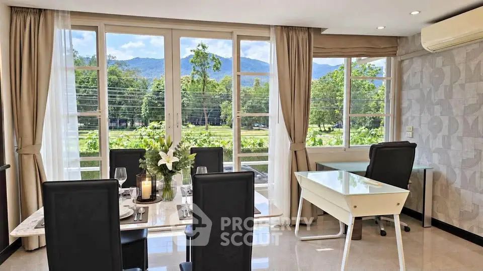 Elegant dining area with scenic mountain view through large windows, featuring modern furniture and stylish decor.