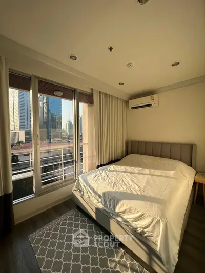Spacious bedroom with city view and modern furnishings