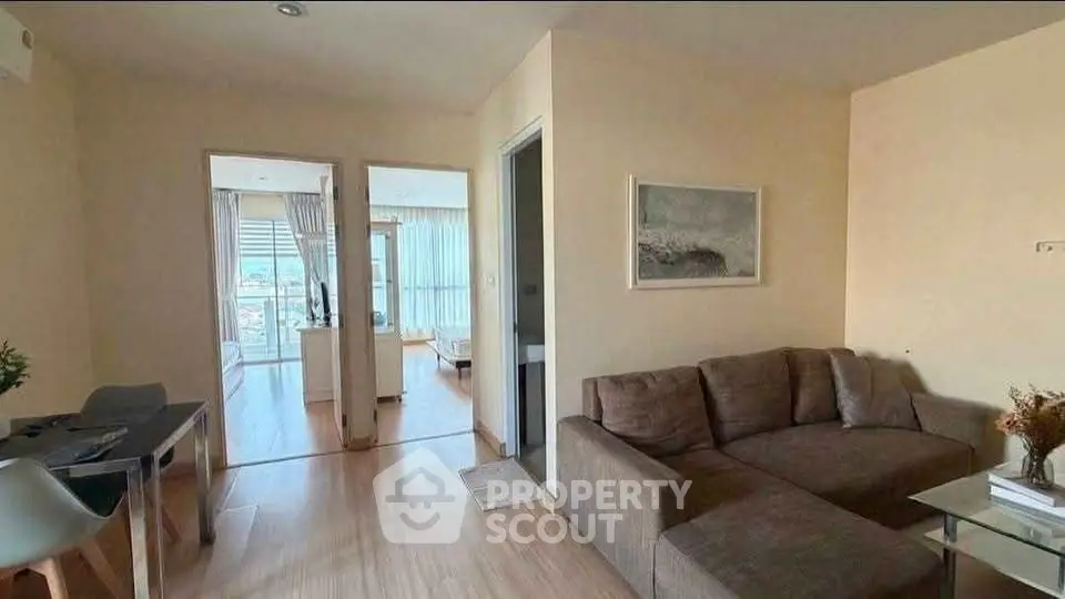 Modern living room with cozy sofa and dining area in open layout apartment