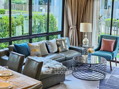 Luxurious living room with modern decor and large windows overlooking a garden.
