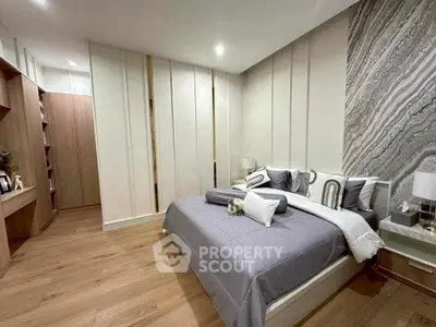 Luxurious modern bedroom with stylish decor and ample storage space.