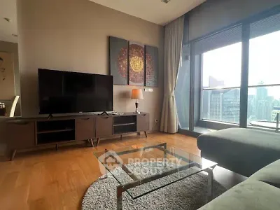 Modern living room with city view, stylish decor, and floor-to-ceiling windows.