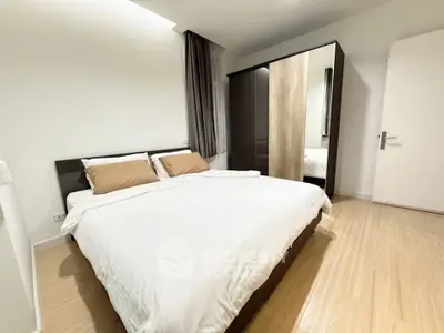 Spacious bedroom with modern decor and ample natural light