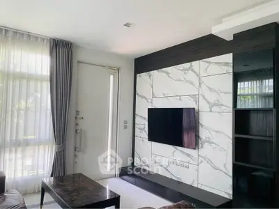 Modern living room with marble accent wall and sleek TV setup