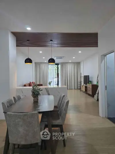 Spacious modern living and dining area with elegant decor and natural light.
