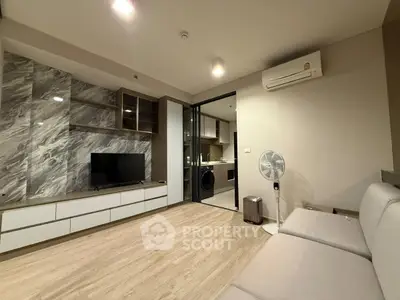 Modern living room with sleek design, featuring a TV, air conditioning, and stylish marble accents.