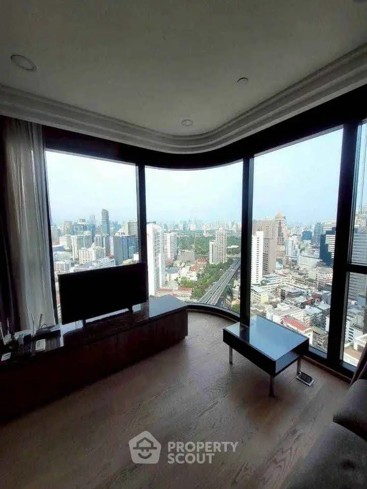Luxurious living room with panoramic city view and modern decor.