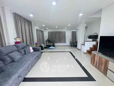 Spacious living room with modern decor and ample natural light