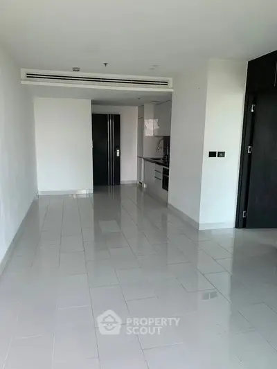 Spacious modern apartment with sleek kitchen and open layout, perfect for contemporary living.