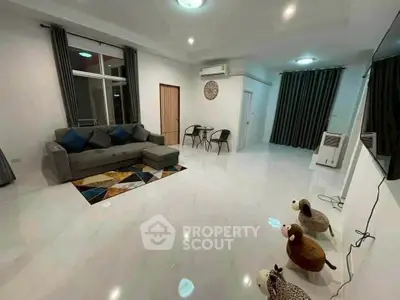 Spacious modern living room with stylish decor and ample natural light, perfect for relaxation and entertainment.