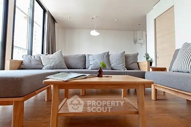 Spacious modern living room with large windows and stylish furniture