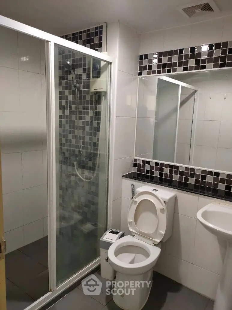 Modern bathroom with glass shower and sleek tile design