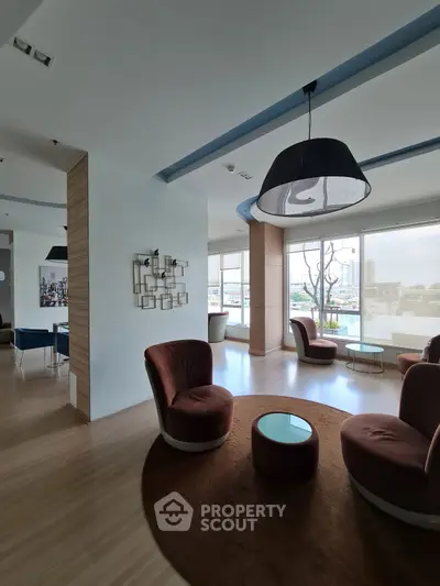 Stylish modern living room with chic furniture and city view, perfect for urban living.
