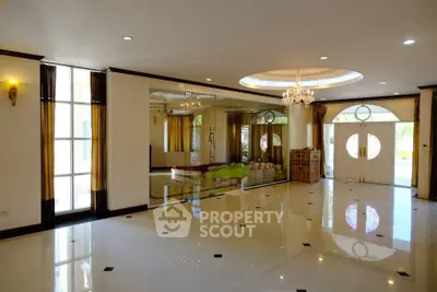 Spacious luxury living room with elegant chandelier and large windows