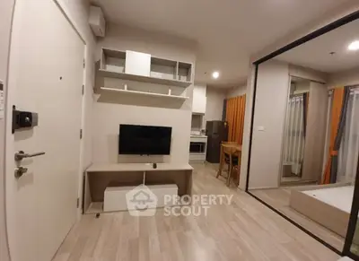 Modern living room with TV, open layout, and wooden flooring