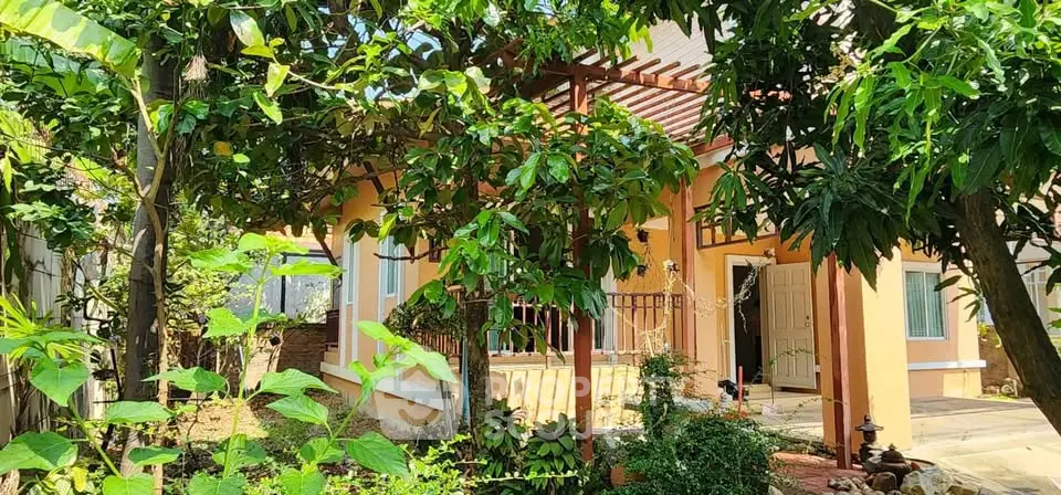Charming house with lush garden and inviting entrance in a serene setting.