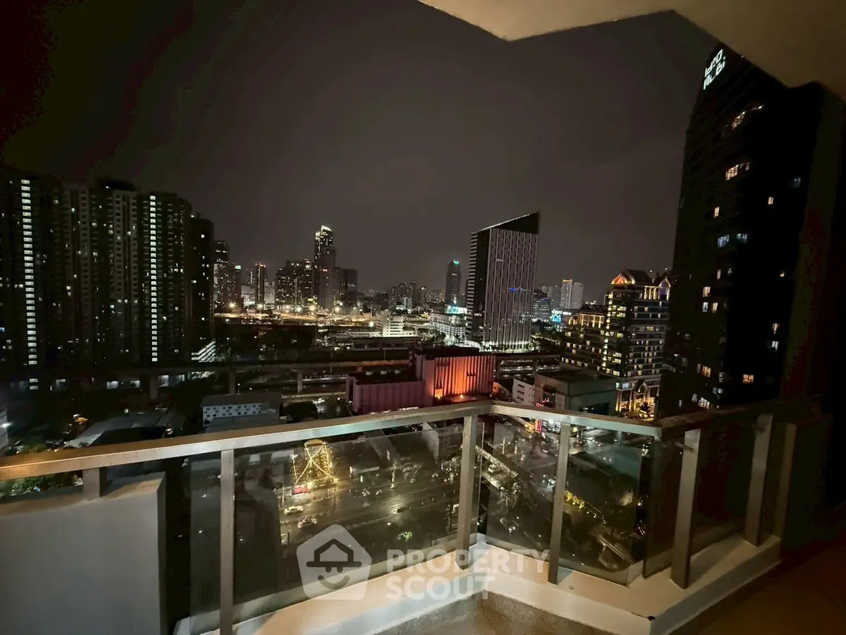 Stunning city skyline view from a modern balcony at night, perfect for urban living.