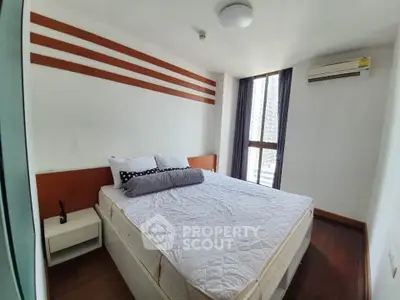 Spacious bedroom with modern design and natural light in a stylish apartment.