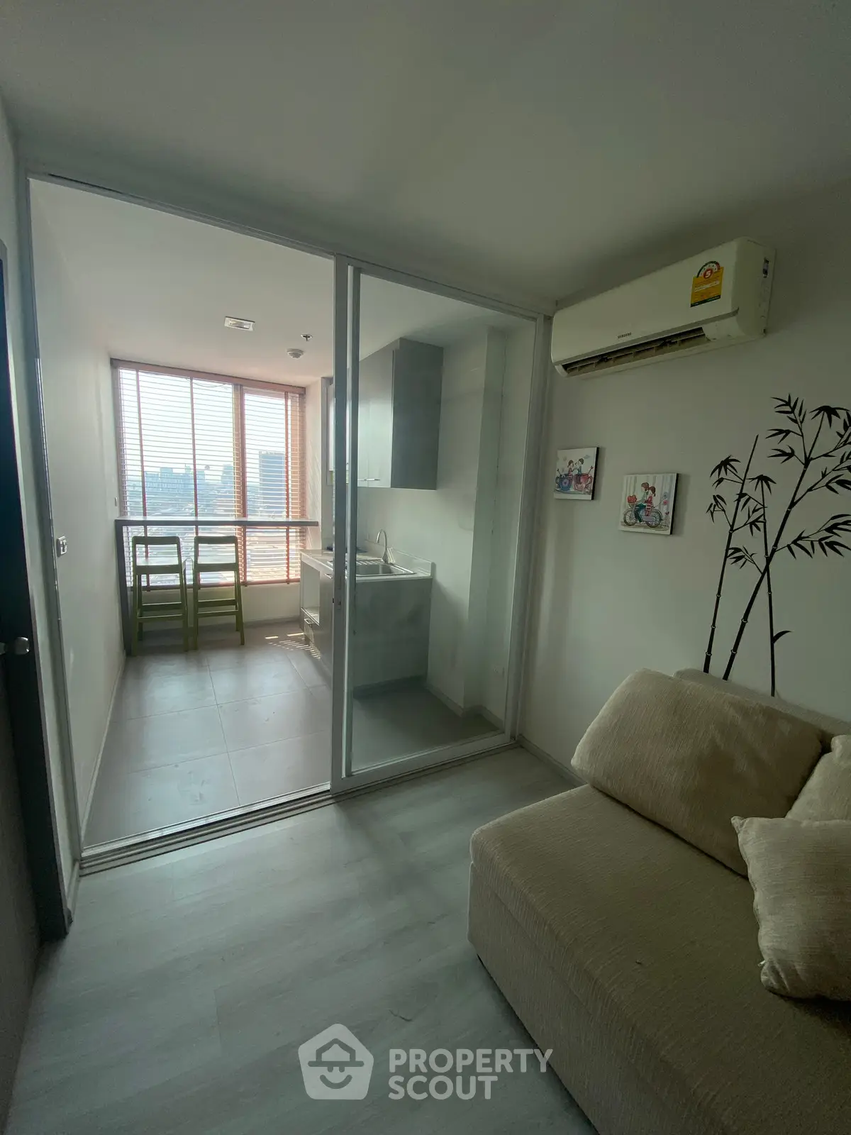 Modern compact living room with glass partition and city view