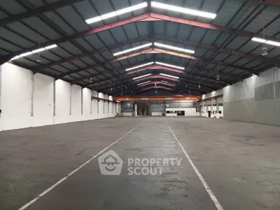Spacious industrial warehouse with high ceilings and ample storage space.