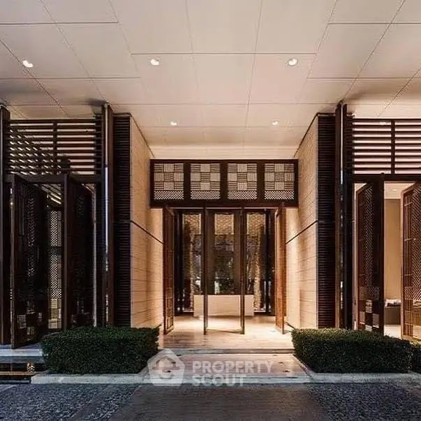 Luxurious building entrance with modern architectural design and elegant lighting.