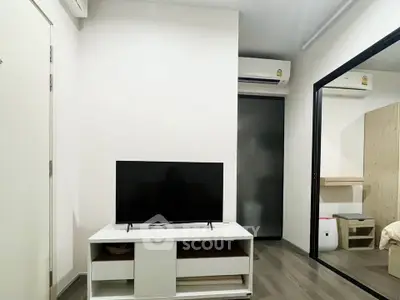 Modern living room with sleek TV stand and air conditioning, perfect for cozy urban living.